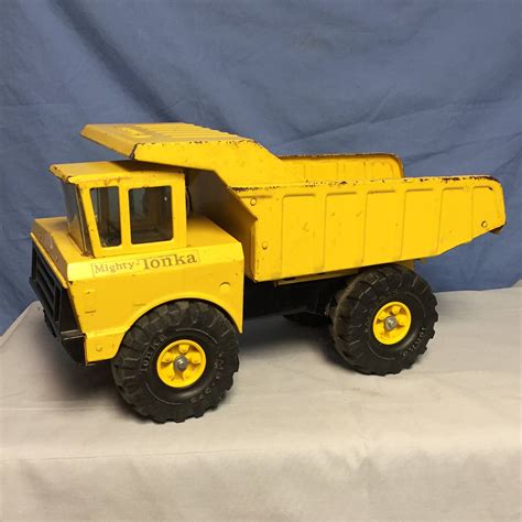 Classic tonka trucks - An aged, rusted Tonka toy chest, ajar with beams of light unveiling …